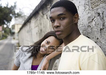 African American teenagers leaning against wall outside View Large Photo Image Stock Photography - African American teenagers leaning against wall outside. Fotosearch