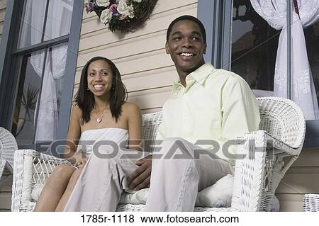 Stock Photo - African American teenagers sitting together on porch. Fotosearch