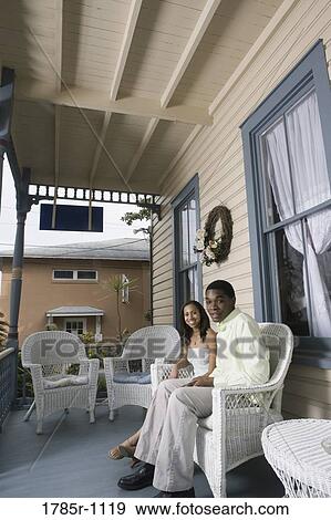 Stock Photo - African American teenagers sitting together on porch. Fotosearch