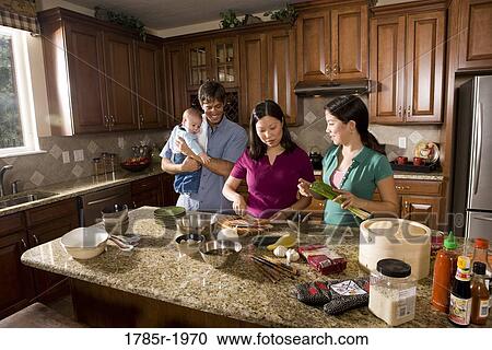 Asian-Caucasian family preparing dinner together View Large Photo Image Stock Image - Asian-Caucasian family preparing dinner together. Fotosearch