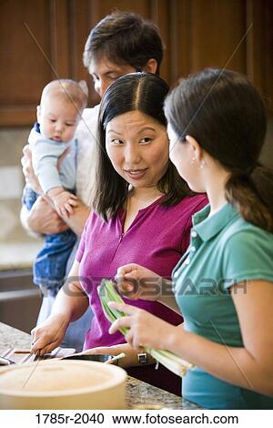 Asian-Caucasian family preparing dinner together View Large Photo Image Stock Image - Asian-Caucasian family preparing dinner together. Fotosearch