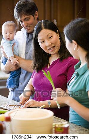 Asian-Caucasian family preparing dinner together View Large Photo Image Stock Image - Asian-Caucasian family preparing dinner together. Fotosearch