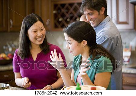 Asian-Caucasian family preparing dinner together View Large Photo Image Stock Image - Asian-Caucasian family preparing dinner together. Fotosearch