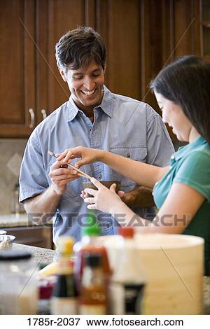 Asian girl showing Caucasian man how to use chopsticks View Large Photo Image Stock Photo - Asian girl showing Caucasian man how to use chopsticks. Fotosearch