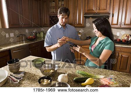 Asian girl showing man how to use chopsticks View Large Photo Image Stock Photo - Asian girl showing man how to use chopsticks. Fotosearch