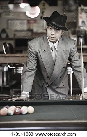 Asian man in pool hall View Large Photo Image Stock Image - Asian man in pool hall. Fotosearch