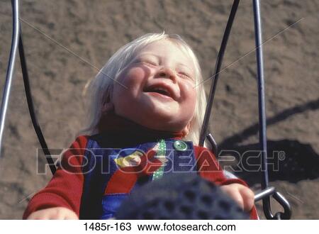 Baby sitting in a swing View Large Photo Image Stock Image - Baby sitting in a swing. Fotosearch