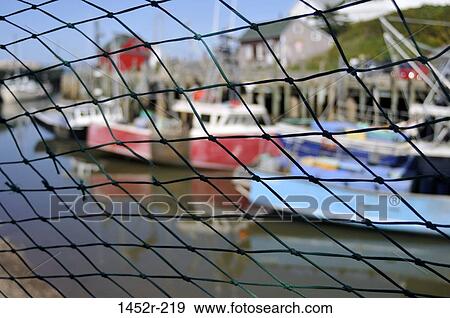 Boats viewed through net at a harbor, Nova Scotia, Canada View Large Photo Image Stock Photo - Boats viewed through net at a harbor, Nova Scotia, Canada. Fotosearch