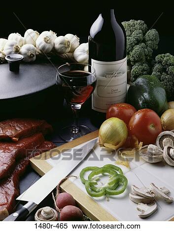 Bottle and glass of red wine near a cutting board View Large Photo Image Stock Photography - Bottle and glass of red wine near a cutting board. Fotosearch