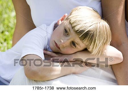 Stock Photo - Boy lying on mother's lap. Fotosearch