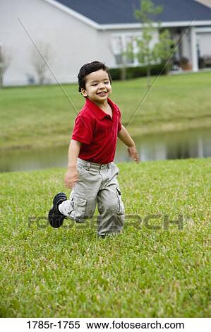 Boy running on lawn View Large Photo Image Stock Photography - Boy running on lawn. Fotosearch