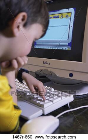 Boy using a computer View Large Photo Image Stock Image - Boy using a computer. Fotosearch