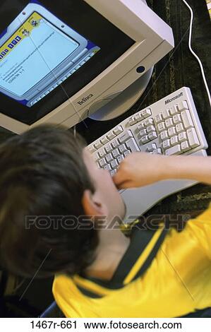 Boy using a computer View Large Photo Image Stock Image - Boy using a computer. Fotosearch