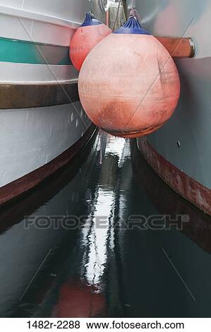 Buoys between boats, Port McNeill, Vancouver Island, British Columbia, Canada View Large Photo Image Stock Photo - Buoys between boats, Port McNeill, Vancouver Island, British Columbia, Canada. Fotosearch