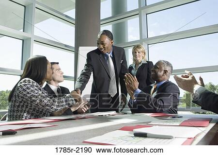 Business colleagues applauding in a meeting View Large Photo Image Stock Image - Business colleagues applauding in a meeting. Fotosearch