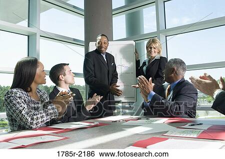 Business colleagues applauding in a meeting View Large Photo Image Stock Photograph - Business colleagues applauding in a meeting. Fotosearch