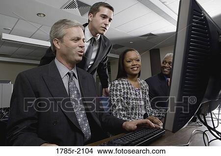 Business colleagues at a computer training seminar View Large Photo Image Picture - Business colleagues at a computer training seminar. Fotosearch