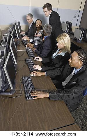 Business colleagues at a computer training seminar View Large Photo Image Picture - Business colleagues at a computer training seminar. Fotosearch