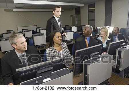 Business colleagues at a computer training seminar View Large Photo Image Stock Image - Business colleagues at a computer training seminar. Fotosearch