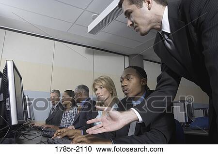 Business colleagues at a computer training seminar View Large Photo Image Stock Image - Business colleagues at a computer training seminar. Fotosearch