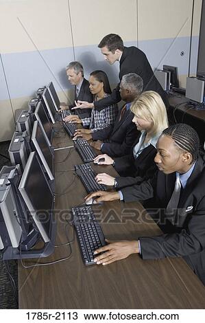 Business colleagues at a computer training seminar View Large Photo Image Stock Image - Business colleagues at a computer training seminar. Fotosearch