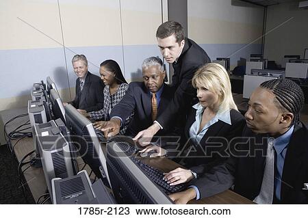 Business colleagues at a computer training seminar View Large Photo Image Stock Image - Business colleagues at a computer training seminar. Fotosearch