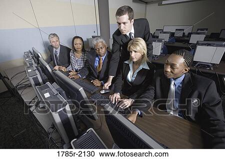 Business colleagues at a computer training seminar View Large Photo Image Stock Image - Business colleagues at a computer training seminar. Fotosearch