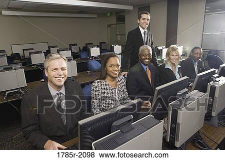 Business colleagues at a computer training seminar View Large Photo Image Stock Photo - Business colleagues at a computer training seminar. Fotosearch
