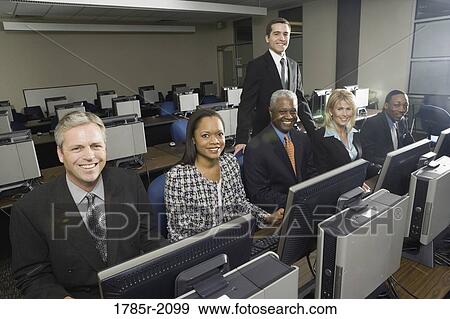 Business colleagues at a computer training seminar View Large Photo Image Stock Photo - Business colleagues at a computer training seminar. Fotosearch