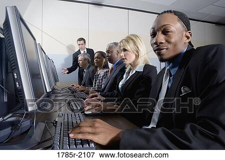 Business colleagues at a computer training seminar View Large Photo Image Stock Photo - Business colleagues at a computer training seminar. Fotosearch