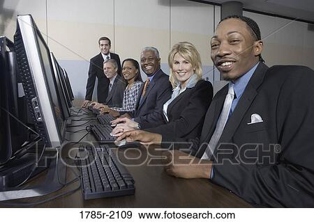Business colleagues at a computer training seminar View Large Photo Image Stock Photo - Business colleagues at a computer training seminar. Fotosearch