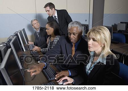 Business colleagues at a computer training seminar View Large Photo Image Stock Photo - Business colleagues at a computer training seminar. Fotosearch