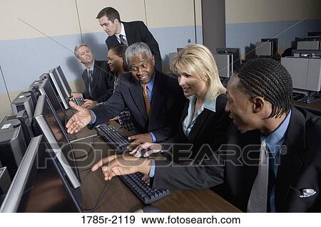 Stock Photo - Business colleagues at a computer training seminar. Fotosearch