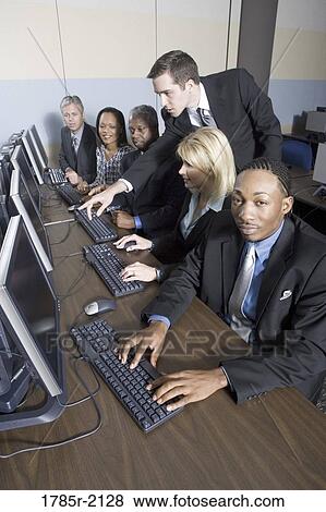 Business colleagues at a computer training seminar View Large Photo Image Stock Photo - Business colleagues at a computer training seminar. Fotosearch