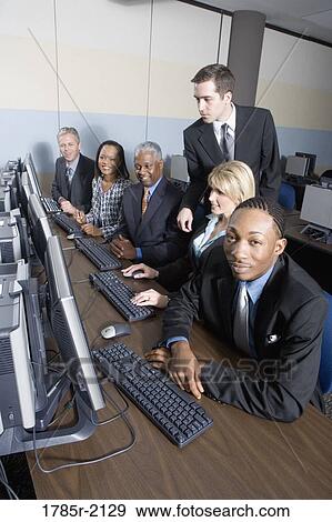 Business colleagues at a computer training seminar View Large Photo Image Stock Photo - Business colleagues at a computer training seminar. Fotosearch