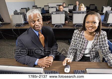Business colleagues at a computer training seminar View Large Photo Image Stock Photo - Business colleagues at a computer training seminar. Fotosearch