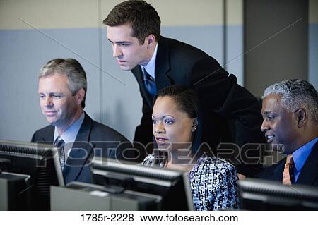 Stock Photo - Business colleagues at a computer training seminar. Fotosearch