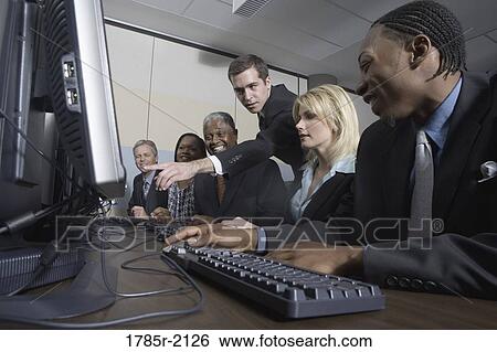 Business colleagues at a computer training seminar View Large Photo Image Stock Photograph - Business colleagues at a computer training seminar. Fotosearch