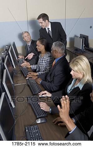 Business colleagues at a computer training seminar View Large Photo Image Stock Photography - Business colleagues at a computer training seminar. Fotosearch