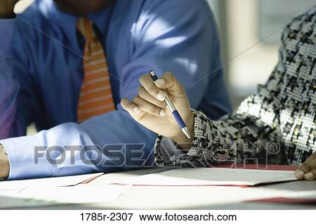 Business colleagues working in an office View Large Photo Image Stock Photo - Business colleagues working in an office. Fotosearch