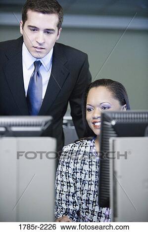 Business colleagues working in an office View Large Photo Image Stock Photograph - Business colleagues working in an office. Fotosearch