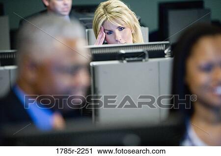 Business colleagues working in an office at computers View Large Photo Image Stock Image - Business colleagues working in an office at computers. Fotosearch