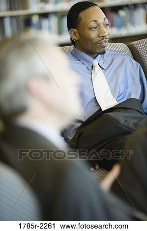 Businessmen in a meeting View Large Photo Image Stock Image - Businessmen in a meeting. Fotosearch