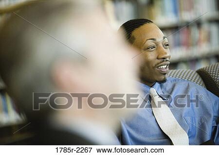 Stock Photo - Businessmen in a meeting. Fotosearch