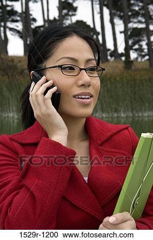 Stock Image - Businesswoman talking on a mobile phone. Fotosearch