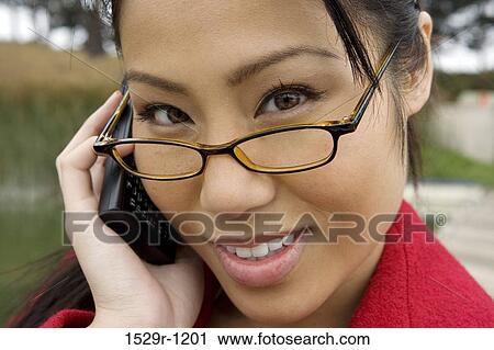 Stock Image - Businesswoman talking on a mobile phone. Fotosearch