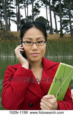 Stock Photo - Businesswoman talking on a mobile phone. Fotosearch