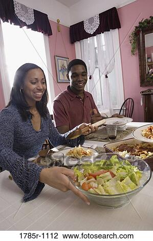 Cheerful brother and sister sitting at dining table View Large Photo Image Stock Image - Cheerful brother and sister sitting at dining table. Fotosearch