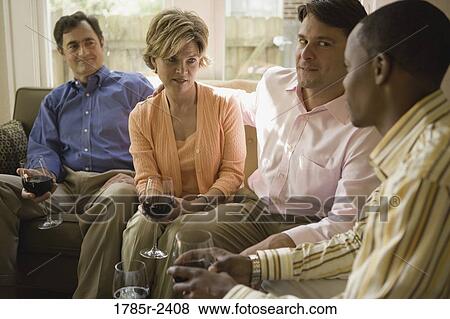 Cheerful family having drinks in a house View Large Photo Image Stock Photo - Cheerful family having drinks in a house. Fotosearch
