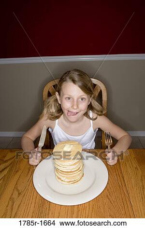 Child ready to eat huge stack of pancakes View Large Photo Image Picture - Child ready to eat huge stack of pancakes. Fotosearch